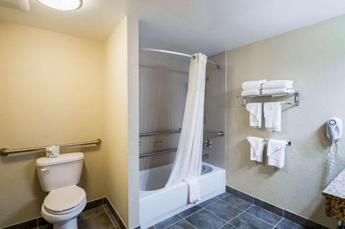 a bathroom with a toilet and a bath tub at Quality Inn & Suites Hagerstown in Hagerstown