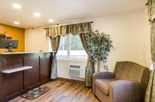 a waiting room with a chair and a window at Rodeway Inn Middleboro-Plymouth in Middleboro