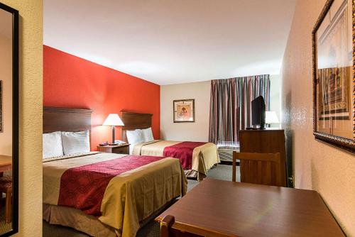 a hotel room with two beds and a table at Econo Lodge Andrews AFB in Clinton