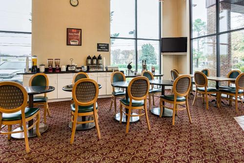 a restaurant with tables and chairs and a counter at Econo Lodge Andrews AFB in Clinton