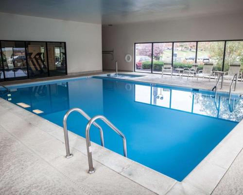 a large pool with blue water in a building at Sleep Inn & Suites Hagerstown in Hagerstown