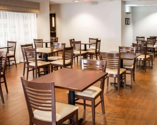 a dining room with wooden tables and chairs at Sleep Inn & Suites Hagerstown in Hagerstown