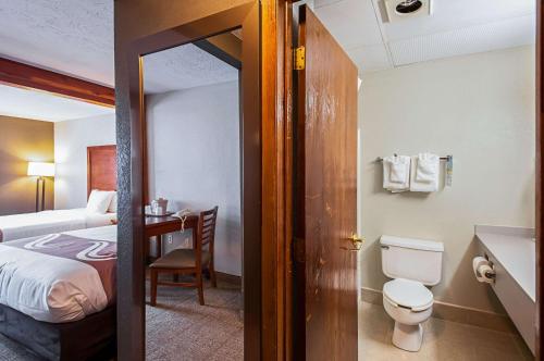 a bathroom with a bed and a toilet in a room at Quality Inn Salisbury in Salisbury