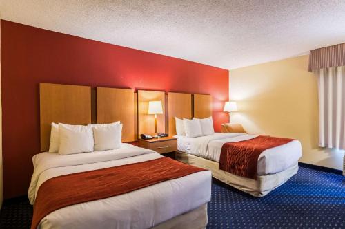 a hotel room with two beds with red walls at Comfort Inn Washington DC Joint Andrews AFB in Clinton