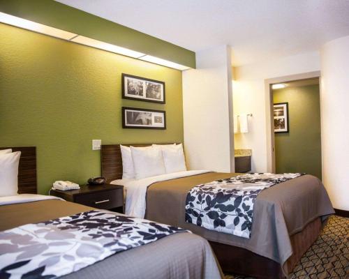 a hotel room with two beds and green walls at Sleep Inn Rockville in Rockville