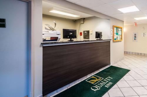a lobby with a bar with the calgary golden chargers logo at Quality Inn Solomons - Beacon Marina in Solomons