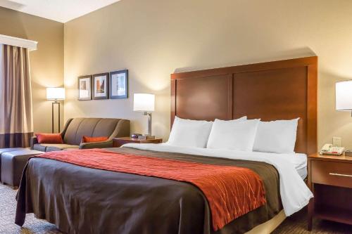 a hotel room with a bed and a chair at Comfort Inn Frederick - Ballenger Creek in Frederick