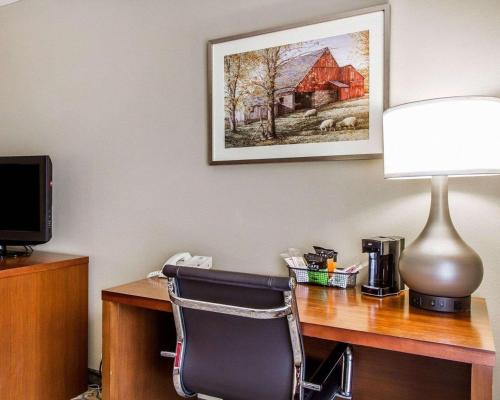 a desk with a chair and a desk with a lamp at Comfort Inn Brunswick in Brunswick
