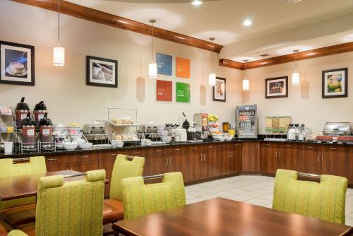 a restaurant with a table and chairs and a counter at Comfort Inn & Suites Lexington Park in Lexington Park