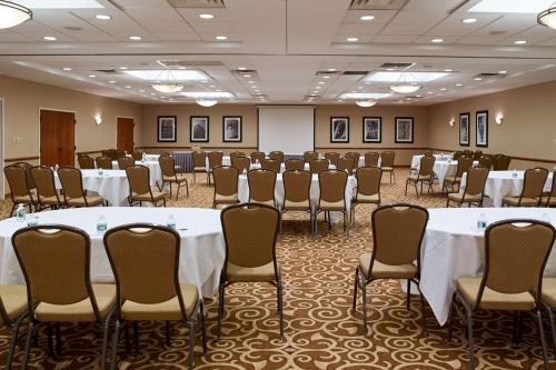 a conference room with tables and chairs in it at Clarion Hotel Airport in Portland