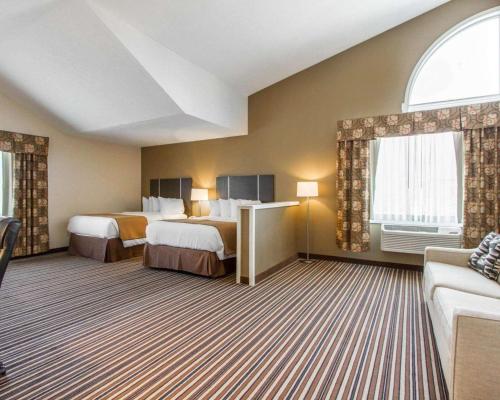 a hotel room with two beds and a couch at Quality Inn & Suites South Portland in South Portland