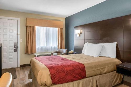 a hotel room with a large bed and a window at Econo Lodge Freeport - Brunswick Area in Freeport