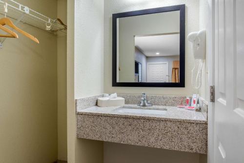 a bathroom with a sink and a mirror at Econo Lodge Freeport - Brunswick Area in Freeport