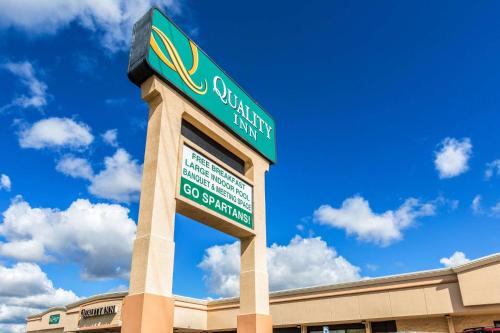 a sign for a shopping center in front of a building at Quality Inn University Lansing in Lansing