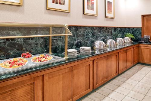 a buffet line with plates and bowls of food at Clarion Hotel Airport Portland in Portland