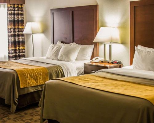 a hotel room with two beds and a telephone at Comfort Inn in Birch Run