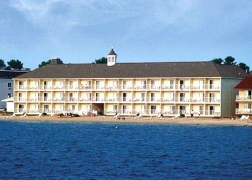 a large hotel on the shore of a body of water at Comfort Inn Lakeside in Mackinaw City