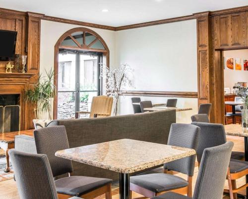 a living room with a table and chairs at Quality Inn in Southfield