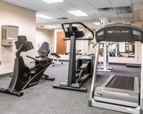a gym with treadmills and ellipticals in a room at Quality Inn in Southfield