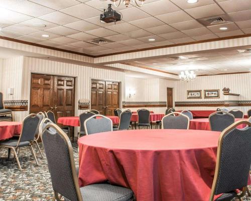 a conference room with red tables and chairs at Quality Inn in Southfield