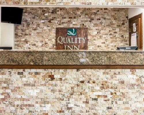 a brick wall with a loyalty inn sign on it at Quality Inn in Southfield