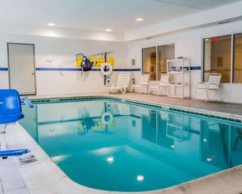 a swimming pool with blue water in a building at Quality Inn I-94 near Wings Stadium in Kalamazoo