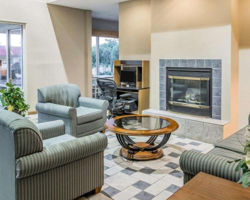 a living room with couches and a fireplace at Quality Inn Kalamazoo near Wings Stadium in Kalamazoo