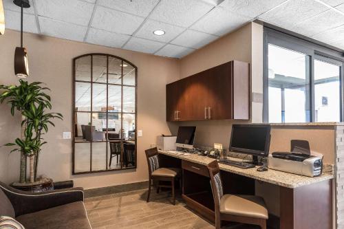 an office with a desk with a computer on it at Comfort Inn Bay City - Riverfront in Bay City