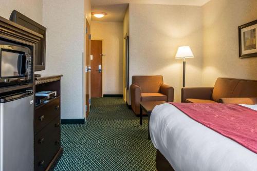a hotel room with a bed and a television at Comfort Suites Canton - Detroit in Canton