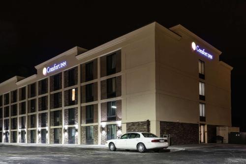 a hotel with a car parked in front of it at Comfort Inn Bay City - Riverfront in Bay City