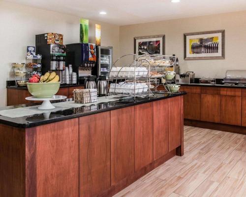 a kitchen with a counter with a bowl of fruit at Quality Inn & Suites Warren - Detroit in Warren