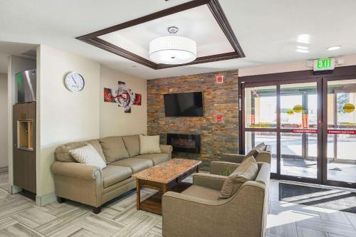a living room with two couches and a fireplace at Quality Inn & Suites Holland in Holland
