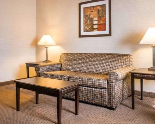 a living room with a couch and two tables at Quality Inn & Suites Next to the Casino in Ceresco