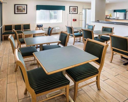 a waiting room with tables and chairs at Quality Inn near Northtown Mall & National Sports Center in Coon Rapids