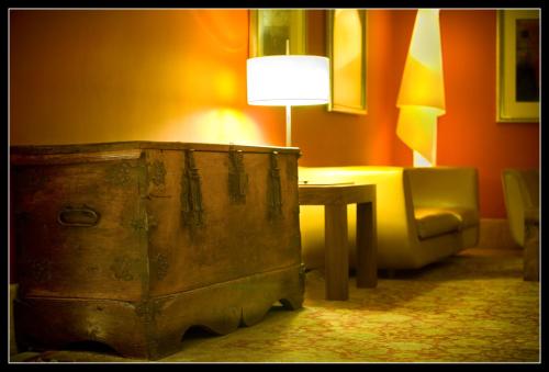 a room with a table and a lamp and a chair at Sercotel Palacio de Tudemir in Orihuela