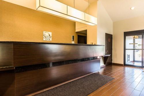 a lobby with a large wooden counter in a building at Sleep Inn Springfield South I60 near Medical District in Springfield