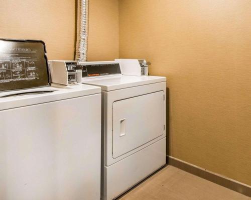 a washer and dryer with a laptop on top of it at Quality Inn Cameron in Cameron