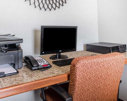 a desk with a computer monitor and a printer at Quality Inn US65 & E Battlefield Rd Springfield in Springfield