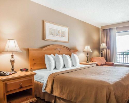 a hotel room with a bed and a window at Quality Inn South Springfield in Springfield