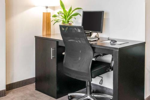 an office with a desk with a computer and a chair at Sleep Inn in St. Charles