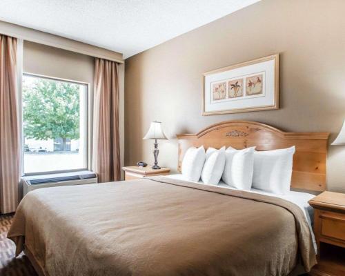 a hotel room with a bed and a window at Quality Inn US65 & E Battlefield Rd Springfield in Springfield