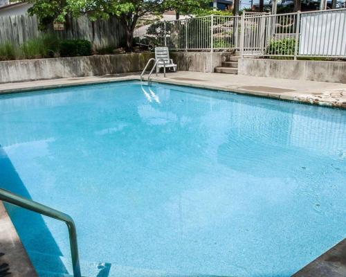a large blue swimming pool with a chair in it at Sleep Inn & Suites Lake of the Ozarks in Camdenton