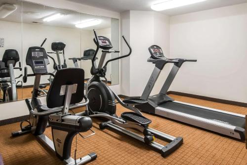 a gym with several exercise bikes in a room at Sleep Inn in St. Charles