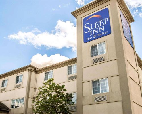 a building with a sign on the side of it at Sleep Inn & Suites Lake of the Ozarks in Camdenton