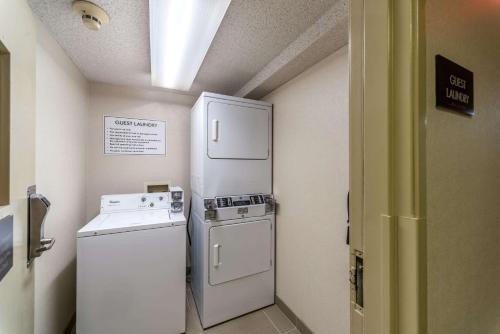 a small kitchen with a refrigerator and a washer at Comfort Inn Festus-St Louis South in Festus