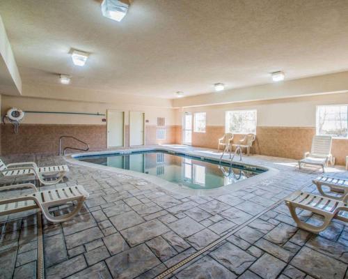 a pool in a hotel room with chairs at Comfort Suites Columbia - University Area in Columbia