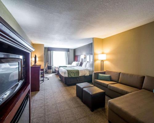 a hotel room with a bed and a couch at Comfort Suites Columbia - University Area in Columbia