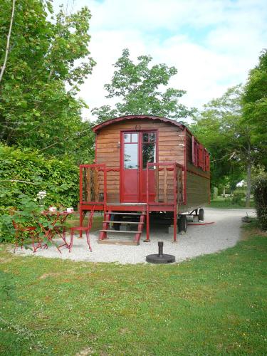 a tiny house on display in a park at Les Chalets des Mousquetaires in Mirepoix