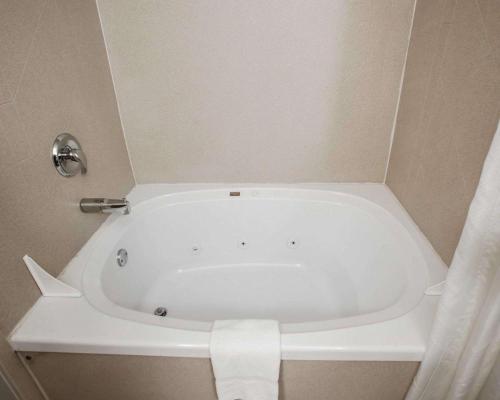 a white bath tub in a bathroom with a curtain at Comfort Inn Lees Summit - Hwy 50 & Hwy 291 in Lees Summit