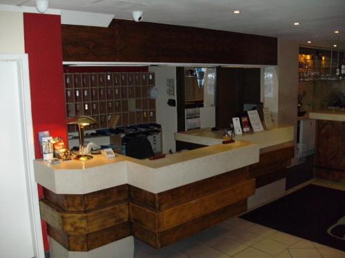a bar in a restaurant with a counter at Hotel Adler in Augsburg